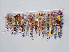 an arrangement of flowers hanging on a wall