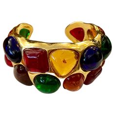 1980s Chanel gold toned cuff bangle adorned with 17 multicolored Gripoix. Stamped 26 made in France. Circumference measures approximately 16 cm Width 3.3 cm Opening 1.6 cm. Comes with dust bag and box. Condition: Minor signs of wear. Generally in very good condition Chanel Vintage Jewelry, 1980s Chanel, Chanel Clothes, Gold Vintage Jewelry, Retro Jewelry, Gold Box, Chanel Jewelry, Vintage Bracelet, Funky Jewelry