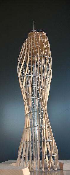 a tall wooden sculpture sitting on top of a table