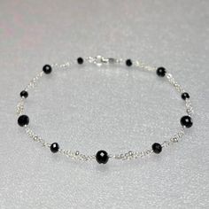 Premium-quality, genuine black tourmaline beaded bracelet, wire-wrapped in sterling silver This dainty bracelet is designed with genuine 4 and 3.5 mm, AAA black tourmaline gemstones, alternately and evenly spaced along segments of double strand sterling silver chain.  The micro-faceting on these highly-polished stones, along with the tiny dots on the chain add extra sparkle and shine.  This bracelet is completed with a sterling silver lobster claw clasp, with two smaller rondelles of 3 mm on both sides. This beautiful and feminine bracelet that will take you from day to night and suitable for any occasion ! Black Tourmaline is said to be a protective and grounding stone which repels and blocks all negative energies.   Details: *  length: please choose at check-out black tourmaline rondelle Black Bracelet Women Silver, Beaded Bracelets With Black Beads, Minimalist Silver Beaded Bracelet With Black Beads, Black Crystal Bracelet With Silver Beads As Gift, Gift Black Crystal Bracelet With Silver Beads, Minimalist Black Sterling Silver Bracelet Gift, Black Sterling Silver Bracelets With Silver Beads, Minimalist Black Sterling Silver Beaded Bracelets, Minimalist Black Sterling Silver Bracelet