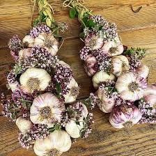 several bouquets of flowers sitting on top of a wooden table