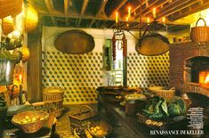 an old fashioned kitchen with baskets hanging from the ceiling