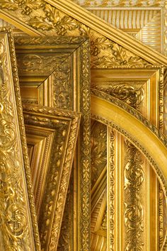 an ornate gold frame with intricate designs on the edges and sides is shown in close up