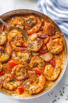 a skillet filled with shrimp and tomatoes