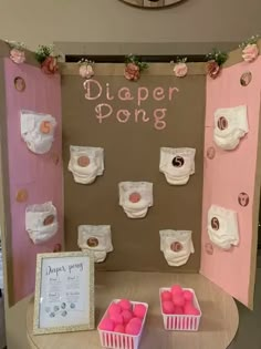 a display with diapers and pink balls on it