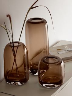 two brown vases sitting on top of a table