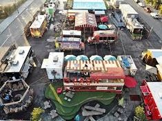 an aerial view of a parking lot with many trucks and trailers parked in the lot