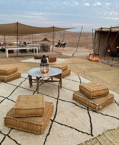 an outdoor area with couches and tables in the desert