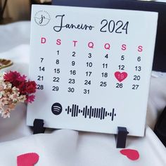 a table with a calendar and flowers on it