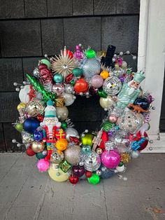 a wreath made out of ornaments sitting on the ground