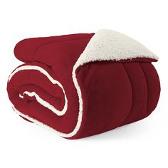 a red and white comforter with sherpam on the bottom is folded up