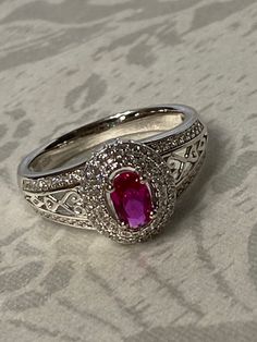 Very Lovely!! High Gallery Sterling Silver 925, 1ct Oval Cut Hot Pink/ Red CZ Solitaire with accents, Gorgeous Gallery, fancy detail! Center stone tests as a Ruby, I am sure it is Lab created.  Size- 8 Center Stone Measures : 6mm x 4mm  Weight : 4.1 grams  Stamped: 925 GSK Condition : very good condition !  Thank you for Visiting! Exquisite Silver Ruby Ring With Halo Setting, Luxury Hallmarked Silver Ruby Ring, Luxury Emerald-cut Ruby Ring In Sterling Silver, Vintage Silver Ruby Ring, Hallmarked, Luxury Multi-stone Ruby Ring In Sterling Silver, Bling Rings, Halo Rings, Multi Stone, 1 Carat