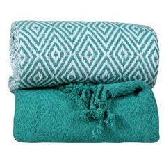 two green and white blankets with tassels on them