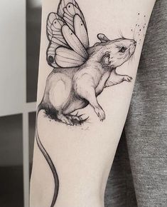 a woman with a tattoo on her arm has a rat in the shape of a butterfly