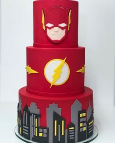 a three tiered cake with the flash symbol on top