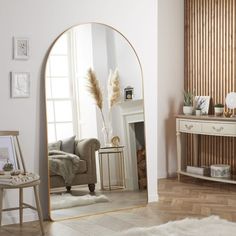 a living room filled with furniture and a large mirror