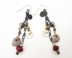 "This dangly pair of long drop earrings has a sterling silver earring wire and measures a little over 3\" from the top of the ear wire. They are an assemblage of mixed chain, tiny vintage buttons, drilled pebbles, handmade lampwork beads and some tiny brass beads. I've added a black wire spiral to each....whatever I've found. I've taken care to mix colors and metals so they can be worn with just about anything.  The earrings are hand made by me, no two pair are exactly alike. Sometimes, when I r Unique Nickel-free Dangle Linear Earrings, Upcycled Earrings, Wire Spiral, Assemblage Earrings, Earring Wire, Faith Jewelry, Handmade Lampwork Bead, Brass Beads, Unusual Jewelry