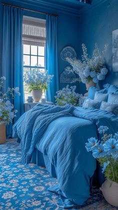 a bedroom with blue walls and flowers in vases on the bed, along with an area rug