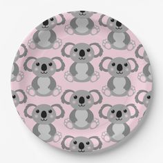 a pink plate with koalas on it and the words koala in grey