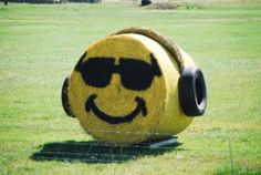 a large hay bale with a smiley face drawn on it