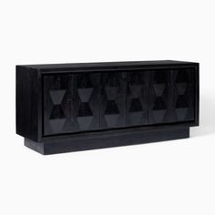 a black cabinet with geometric shapes on the front and sides, against a white background