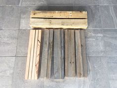 a wooden bench sitting on top of a tiled floor