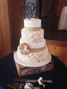 a three tiered wedding cake sitting on top of a table next to a knife