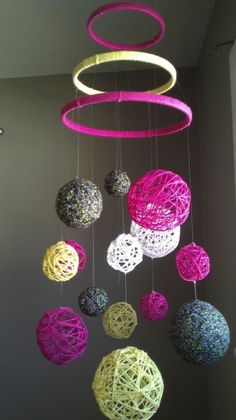 a mobile made out of yarn balls hanging from the ceiling