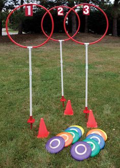 three circles and four cones in the grass with numbers on them