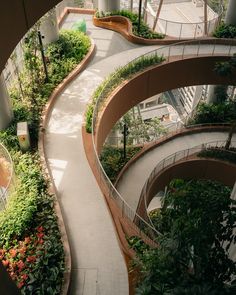 an aerial view of a building with many plants growing on the walls and walkways