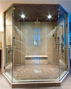 a walk in shower sitting inside of a bathroom