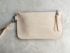 This dreamy white wristlet is giving us all the fashionista feels....how about you? A chic and eco-friendly wristlet made from eco-friendly cork leather is perfect for carrying your cash, cards and phone. Its useful keyring loop for attaching keys make for easier finding in your purse and a detachable wrist strap give you the option to use as a zip pouch inside your bag to keep small essentials organized. SMALL: 7 inches wide, 4.5 inches high LARGE: 8.5 inches wide, 5 inches high See more wristlet bundles and cork leather accessories here:  https://www.etsy.com/shop/hookandrope/?section_id=34318397 White Clutch Bag, Wristlet Pouch, White Clutch, Wristlet Purse, Leather Clutch Bags, Makeup Bags, Zip Wallet, Wristlet Wallet, Leather Wristlet