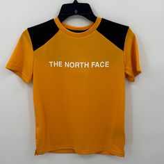 The North Face Boy's Never Stop Tee In Summit Gold Size Large New With Tags-Small Stain On Sleeve (See Picture, Washing Will Remove It) Please Feel Free To Ask Any Questions Before Purchasing Thank You! Yellow Sports T-shirt With Logo Print, Yellow Sporty T-shirt With Letter Print, Sporty Yellow T-shirt With Letter Print, Yellow Short Sleeve Tops For Outdoor, The North Face Crew Neck Top With Letter Print, Black The North Face Crew Neck T-shirt, The North Face Crew Neck Tops For Outdoor, The North Face Black Crew Neck T-shirt, The North Face Letter Print Streetwear Tops