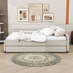 a white bed sitting on top of a wooden floor