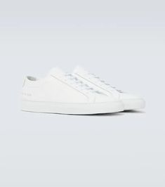 The Original Achilles Low sneakers from Common Projects come in a minimalist all-white leather silhouette resting on a rubber sole and are finished with the brand's signature coding on the outer sides..Sole: leather insole, rubber sole.Toe shape: round toe.Upper: leather.Closure: lace-up.Designer color name: White.Made in Italy.True to size.Half sizes please take the next size up.European sizes Classic White High-top Sneakers With Textured Sole, Classic White Leather High-top Sneakers, White Leather Sneakers With Plain Toe, White High-top Sneakers With Leather Sole For Streetwear, White Leather High-top Sneakers With Leather Sole, Common Projects Shoes, Common Projects, Low Sneakers, Shoes Casual