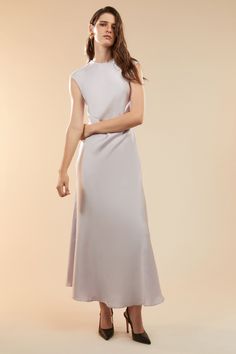 Sultry, elevated and entirely elegant, the Peggy A-line Slip Dress creates a fluid aesthetic that feels feminine and effortless. Made from a satin fabric, it features a high neckline, extended shoulders and an open back to draw the eye. SIZING: True to size. AU: Model wears a size 8 / US: Model wears a size 4.FABRICATION: Main: 100% polyester - A-line - High neckline - Open back