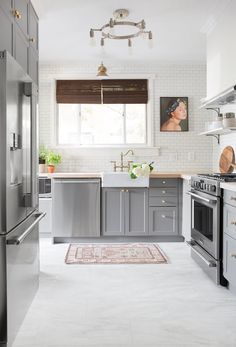 a kitchen with stainless steel appliances and white walls