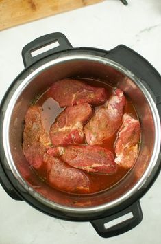 the meat is being cooked in the pot on the stove top and ready to be cooked