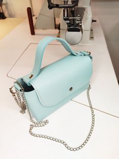 Mini handbag, baby blue leather mini bag, phone bag, miniature handbag, tiny leather bag. This mini handbag is in line with the latest trends. Made of baby blue natural leather, it has no lining or pockets and is finished in raw leather. It fastens with a snap closure. The sides are decorated with three silver-colored rivets, giving it a rockier feel. Additionally, it comes with a chain, allowing you to carry the handbag on your shoulder. Great as a gift for her. Dimensions: Height: 10 cm/ 3 inches Width: 18 cm/ 7 inches Bottom: 7 cm/ 2 inches Total length of the chain: 120 cm/ 47 inches Remember that each of our handbags is hand-sewn in our workshop, offering you the possibility of personalization. You can start by changing the color of the leather or material, add or remove elements (suc Blue Pouch Box Bag For Mobile Phone, Blue Mobile Phone Pouch Box Bag, Light Blue Pouch Bag As Gift, Light Blue Pouch Bag For Gift, Trendy Blue Phone Bag For Everyday Use, Trendy Blue Everyday Phone Bag, Trendy Light Blue Leather Bag, Blue Satchel Box Bag For Gift, Blue Satchel Box Bag For Mobile Phone