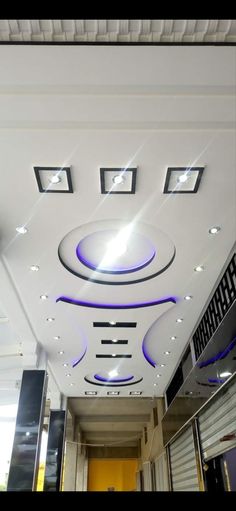 the ceiling is decorated with modern design and lighting fixtures, including square recessed lights