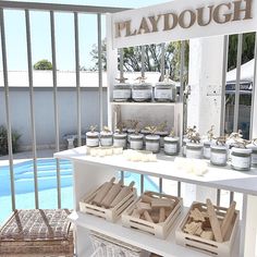 a table that has some food on it near a swimming pool with the words playdough above it