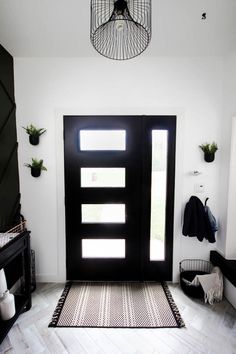 a black and white entryway with an open door