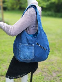 Large, soft, lined denim hobo bag with 3 pockets and nice wide straps.  This large bag is made with upcycled denim and is lined with a cotton fabric in a teal color with small black flowers on it.  There is one large zippered pocket on the inside, along with a hoop to hook your keys onto.  There are two pockets on the outside, one of which is a large zippered pocket.  The straps are 25 inches long and the bag is 20 inches wide by 15 inches deep (all measurements are approximate). Hobo Bag From Old Jeans Free Pattern, Cheap Blue Hobo Bag With Pockets, Cheap Denim Blue Hobo Bag For Daily Use, Cheap Casual Denim Hobo Bag, Cheap Denim Blue Hobo Bag For Women, Cheap Blue Denim Hobo Bag, Cheap Denim Hobo Tote Bag, Cheap Blue Hobo Bag With Handles, Denim Hobo Bag With Pockets For Travel