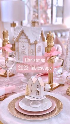 a christmas table setting with pink and gold decorations