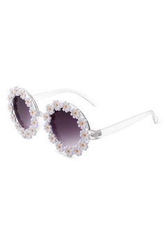 Make a statement with Daisy sunglasses! These fun, round sunglasses feature daisy flowers around each lens giving you the perfect pop of personality. Get noticed in style and stand out from the crowd! Make fashionable statements with Daisy sunglasses! From the bold daisies adorning the lenses to the classic round frames, you'll be the envy of everyone around. Stand out from the rest and show off your unique style with Daisy sunglasses! Frame Material: PlasticLens Material: PCLens Width: 50mmLens Height: 50mmBridge Width: 21mmTemple Length: 136mm100% UVA & UVB Protection Trendy White Round Frame Sunglasses, White Fun Sunglasses For Summer, Fun White Sunglasses For Summer, White Fun Sunglasses For Spring, White Uv Protection Round Frame Sunglasses, Fun White Sunglasses For Spring, Trendy Summer Sunglasses With Round Frame, Playful Polarized Sunglasses For Spring, White Tinted Sunglasses For Spring