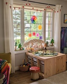 a child's play room with toys in the window sill, and colorful decorations on the windowsill