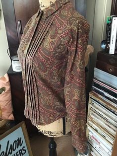 "Vintage 1960's long sleeve blouse. Paisley print in colors of Browns/Rust brown/Olive Drab. Colors are a bit darker than they show in pictures. No makers label. *SCROLL DOWN FOR MEASUREMENTS* CONDITION: No issues noted. No fading to the colors. MEASURES: Bust~34\" Waist~32\" Hips~32\" Sleeve length~22\" Shoulder seam to shoulder seam~13\" Back of collar to bottom~22 1/2\" HOW TO MEASURE: BUST~ Measure loosely around the fullest part of your bust, with the tape straight across and your back, bri Vintage Long Sleeve Blouse With Paisley Print, Vintage Long Sleeve Paisley Print Blouse, Vintage Long Sleeve Paisley Print Top, Vintage Fitted Paisley Print Tops, Vintage Long Sleeve Top With Paisley Print, Vintage Fitted Brown Blouse, Retro Long Sleeve Tops With Paisley Print, Cotton Blouse With Paisley Print For Fall, Vintage Brown Cotton Blouse