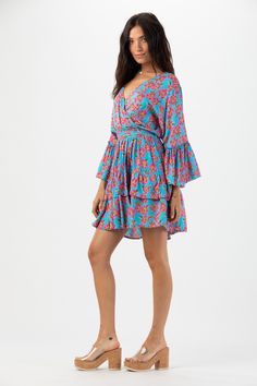 Elevate your wardrobe with our Felix MIni Dress. This charming long sleeve mini dress embraces the whimsical beauty of feminine style. With its flattering silhouette and playful ruffle detailing, this dress is guaranteed to make you feel effortlessly elegant and confident with every wear. Details: 100% Rayon Hand wash in cold water and Lay flat to dry Features: Unlined, V-neck overlap bodice, Tiered flowing sleeves with ruffle detail, Elastic waistband for adjustable fit, Self tie adjustable wai Blue Long-sleeve Dress With Ruffle Hem, Blue Mini Long Sleeve Dress For Spring, Blue Mini Length Long Sleeve Dress For Spring, Long Sleeve Ruffled Mini Dress For Beach, Flirty Long Sleeve Mini Dress For Brunch, Summer Long Sleeve Tiered Dress With Ruffle Hem, Long Sleeve Dress With Ruffle Hem For Brunch, Long Sleeve Tiered Dress With Ruffle Hem For Summer, Flirty Long Sleeve Mini Dress With Floral Print