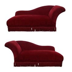 two red couches sitting side by side with fringed ends on the back and sides