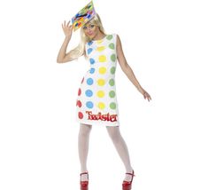 a woman dressed in a polka dot dress and party hat is posing for the camera